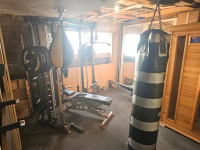a room with a gym with a punching bag and weights at Sandylands in Braystones