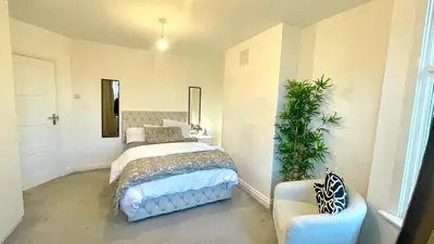 a bedroom with a bed and a chair in it at Luxury Spacious Double Room, Mill Hill, London NW7 3BD in Moffat