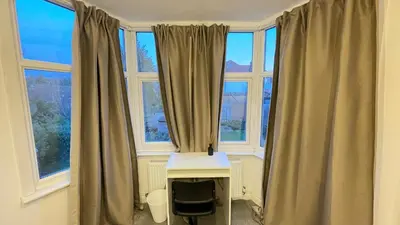 a room with two large windows and a desk with a desk at Luxury Spacious Double Room, Mill Hill, London NW7 3BD in Moffat