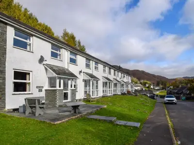 a building with a picnic table in front of it at Quarry's Edge in Chapel Stile
