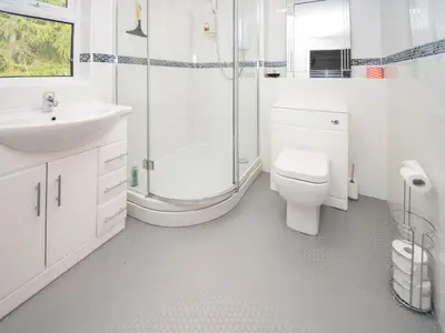 a bathroom with a toilet sink and a shower at Quarry's Edge in Chapel Stile