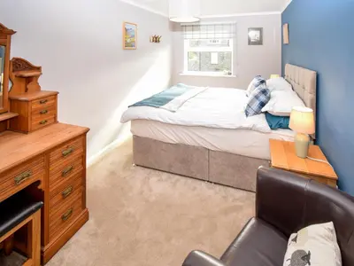 a bedroom with a bed and a desk and a chair at Quarry's Edge in Chapel Stile