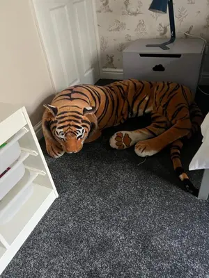 a tiger statue laying on the floor next to a desk at The Holm in Canonbie