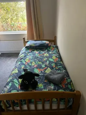 a stuffed animal is sitting on a bed at The Holm in Canonbie