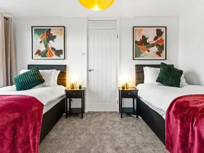 a bedroom with two beds and two night stands at Edison House - Comfy Stay in Stafford in Moffat