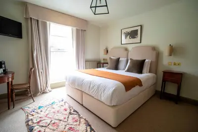 a bedroom with a large bed and a window at Victorian House in Grasmere