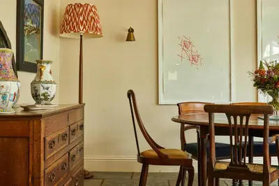 a dining room with a table and chairs and a lamp at Victorian House in Grasmere