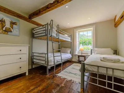a bedroom with two bunk beds and a window at 4 Bed in Nr Keswick oc-sz231 in Braithwaite