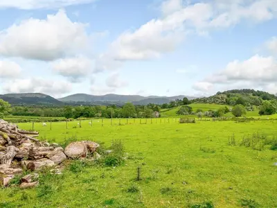 a field of green grass with mountains in the background at 4 Bed in Nr Keswick oc-sz231 in Braithwaite