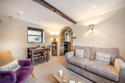 a living room with a couch and a table at 1 Bed in Uldale oc-g34032 in Uldale