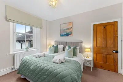 a bedroom with a bed with towels on it at Newlands House - Quiet Keswick Retreat with Stunning Fell Views, Walk to Town in Keswick