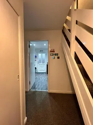 a hallway with a staircase leading into a house at 100 Castle in New Cumnock