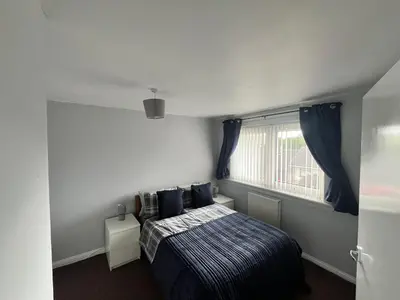 a bedroom with a bed and a window at 100 Castle in New Cumnock
