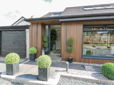a house with plants in front of it at Scotia At The Brig in Annan