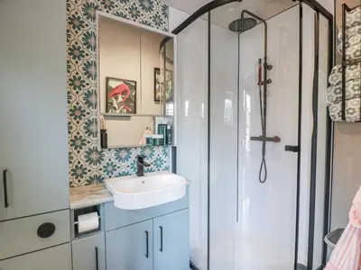 a bathroom with a sink and a shower at Cabin At The Brig in Annan