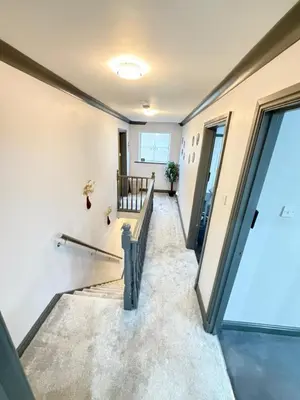 a hallway of a house with a glass door at Seaside Retreat in Harrington