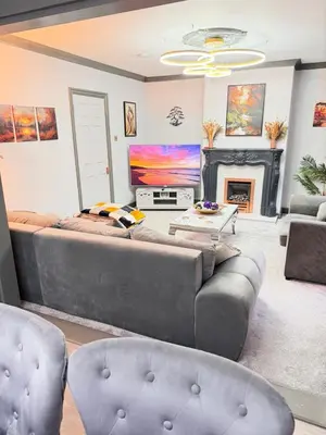 a living room with a large couch and a fireplace at Seaside Retreat in Harrington