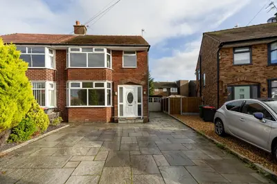a brick house with a car parked in the driveway at FREE parking, LARGE House for Contractors & Families, Sleeps 5, 4 miles to BLACKPOOL in Moffat