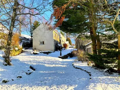 a snow covered yard with trees and a building at 5 Bed in Wigton oc-b34111 in Caldbeck