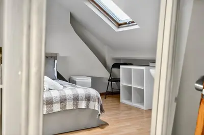 a bedroom with a bed and a skylight at Spacious 5BR Home in Cardiff Bay with Office Area in Moffat