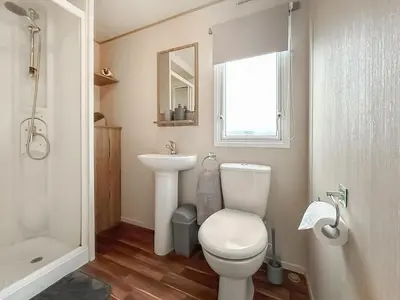 a bathroom with a toilet and a sink at Kjs Holiday Haven in Ayr