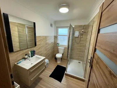 a bathroom with a toilet and a sink and a shower at 3 bedroom luxury Apartment in Prestwick