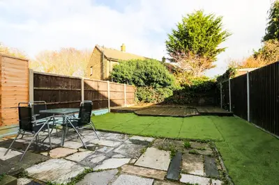 a small garden with a table and chairs on the grass at Southend perfect Stays in Moffat