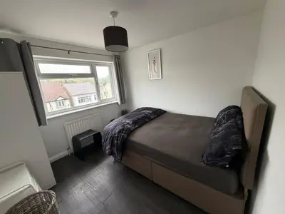 a bedroom with a bed and a window at Private Room in Berkhamsted high street in Moffat