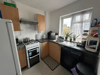 a small kitchen with a stove and a sink at Private Room in Berkhamsted high street in Moffat