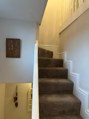 a staircase in a house with a stair case at The Oldest House Located in the heart of Matlock in Moffat
