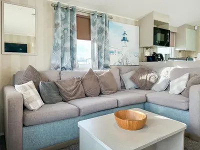 a living room with a couch and a table at H And D Greenan Village in Ayr