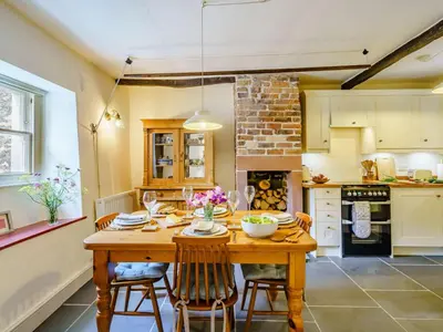 a kitchen with a wooden table and chairs at 2 Bed in Eaglesfield 85288 in Eaglesfield