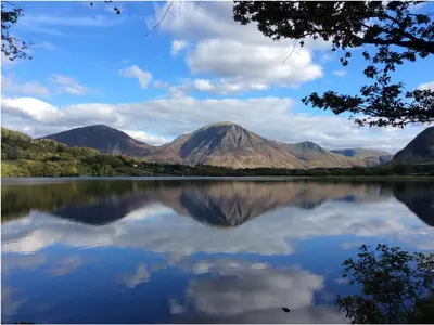 a view of a lake with mountains in the background at 2 Bed in Eaglesfield 85288 in Eaglesfield
