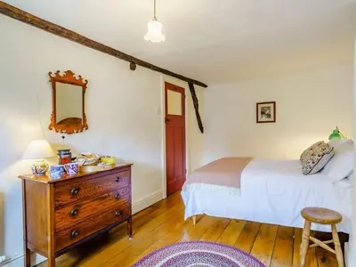a bedroom with a bed and a dresser and a mirror at 2 Bed in Eaglesfield 85288 in Eaglesfield