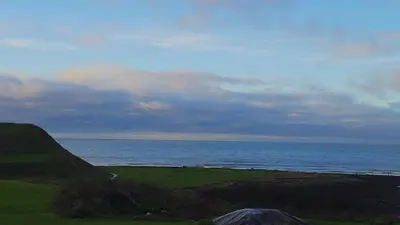 a view of a beach with the ocean in the background at Ruby Atlas Monreith in Monreith