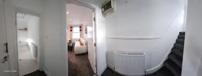 a hallway with a room with a heater and a bedroom at The Spacious Urban Retreat in Douglas