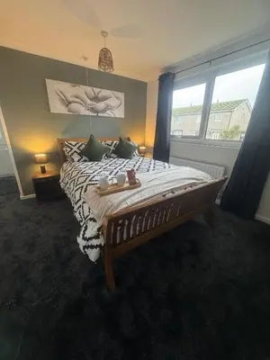 a bedroom with a bed and a large window at West Lakes 3 Bedroom - Sleeps 5 - Self Check In - Fully Furnished House in Workington