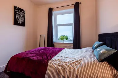 a bedroom with a bed and a window at Mid Street Retreat, Steps from the Beach, Whitehaven in Whitehaven