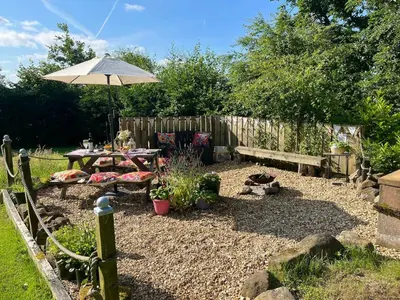 a backyard with a picnic table and an umbrella at Handy for Lake District, detached property in Penruddock