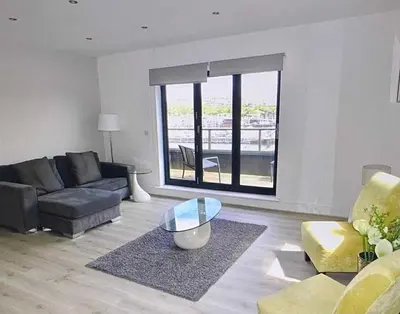 a living room with a couch and a glass table at Bardywell Penthouse - 2 Bedrooms - Sleeps 4 in Whitehaven