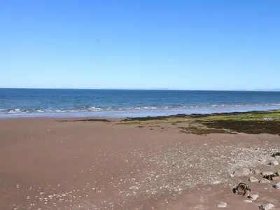 a sandy beach with the ocean in the background at Bardywell Penthouse - 2 Bedrooms - Sleeps 4 in Whitehaven