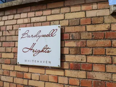 a sign on the side of a brick wall at Bardywell Penthouse - 2 Bedrooms - Sleeps 4 in Whitehaven