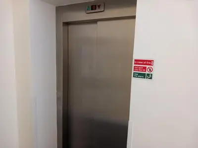 a elevator door in a building with a sign on it at Bardywell Penthouse - 2 Bedrooms - Sleeps 4 in Whitehaven