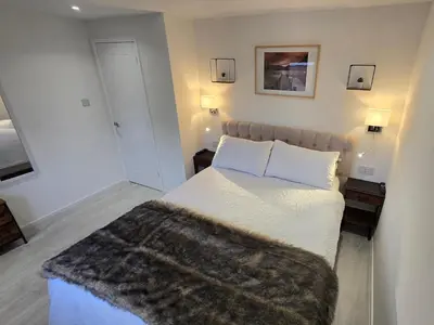 a bedroom with a bed with a furry blanket on it at Exceptional 1 bedroom riverside 2E apartment in Ayr