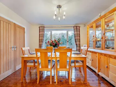a dining room with a wooden table and chairs at Blengfell by Prestige Properties SA in Gosforth