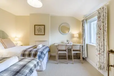 a bedroom with two beds and a desk and a window at 3 Bed in Waberthwaite oc-n34154 in Waberthwaite