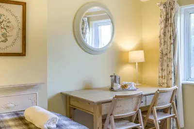 a dining room with a table and chairs and a mirror at 3 Bed in Waberthwaite oc-n34154 in Waberthwaite