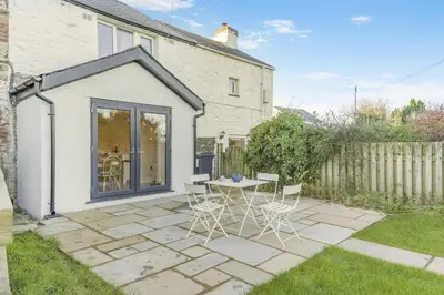 a patio with a table and chairs in a yard at 3 Bed in Waberthwaite oc-n34154 in Waberthwaite