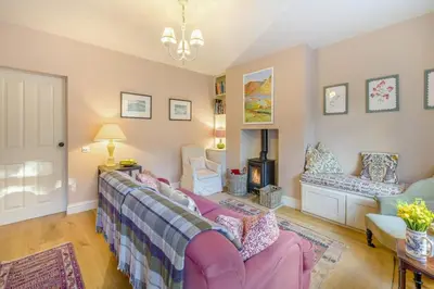 a living room with a pink couch and a fireplace at 3 Bed in Waberthwaite oc-n34154 in Waberthwaite