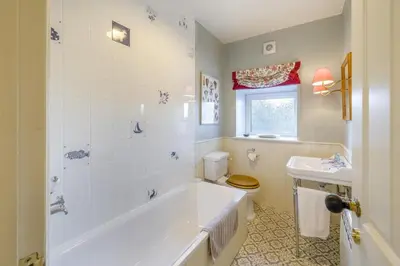 a bathroom with a tub and a toilet and a sink at 3 Bed in Waberthwaite oc-n34154 in Waberthwaite